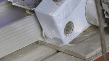 Taş kiremitleri yakın çekim. Yaratıcı. Fayans levhaları kesmek için marangoz makinesi. Taş ürünlerini kesmek için suyu olan kesme makinesi..