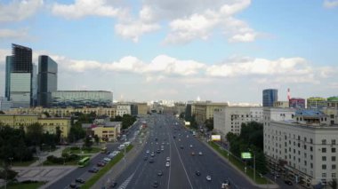 Şehirdeki otoyolun havadan görüntüsü. Şehir manzaralı ve gökdelenli bir şehir yolu. Modern şehirde ulaşım, sokak ışığı, sabah otoyolda ışık yolları, 4K gününde şehir manzarası.