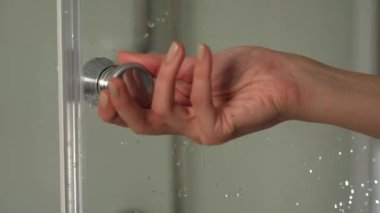 Kapıyı açmak ya da kapatmak için cam duş kabininin kapı kolunu tut. Duş bölmesi 4K yakın çekim kolu