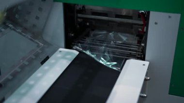 Tatlı hamur işleri paketleme hattı. Medya. Taze wafflelar taşıyıcı hat üzerinde selofan paketleme içine doldurulur