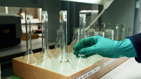 Medical research laboratory equipment. Clip. A scientist hands in gloves taking a flask, concept of research in chemistry, biochemistry and experiments