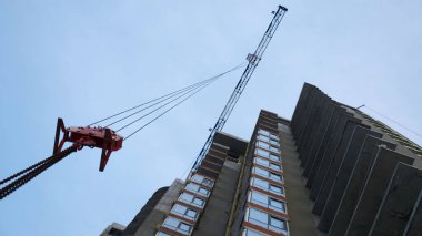 Yüksek vinç inşaat alanında çalışıyor. Şarjör. Konut binalarının inşaatı, inşaat halindeki yüksek binalar.