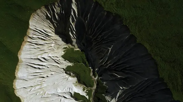 stock image Contrasting green vegetation and white stony mountain peak. Clip. Aerial top view of stunning nature masterpiece