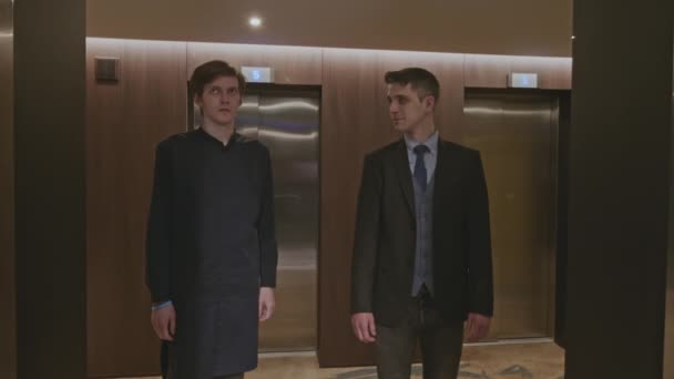 Двое Мужчин Стоят Лифта Зажим Акций Бизнесмены Внутри Здания — стоковое видео
