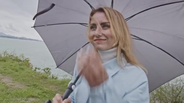 Chica Con Abrigo Azul Claro Con Paraguas Gris Junto Mar — Vídeo de stock