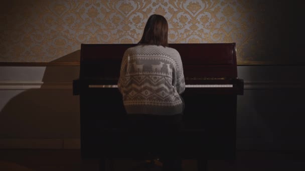 ピアノを弾く女性のリアビュー メディア 若い女性が古いピアノを弾いている 孫娘は古い家でピアノを演奏する — ストック動画