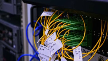 Sarı ve yeşil kablolu optik fiber bağlantı panosunun yakın çekim görüntüsü. Stok görüntüleri. Sunucu odasının iç detayları