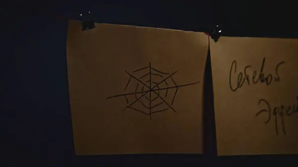 Stock image Mysterious notes on strings. Stock footage. Notes with encrypted signs in night room. Lantern lighting mysterious notes in night office.