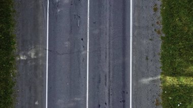 Aerial view of convertible car driving along country road in forest of Georgia in summer on sunny day. Footage. Cinematic drone captures shot of beautiful empty road with the only car clipart