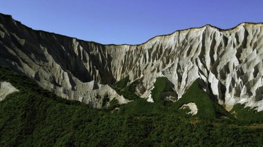 Beautiful aerial of the white cliffs on the south coast of England. Clip. Green summer forested hills and blue sky clipart