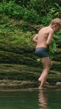 Etrafı yosunlu kayalarla çevrili dağlık gölde banyo yapmak. Yaratıcı. Ormanda yürüyüş yapmak ve küçük gölde banyo yapmak.