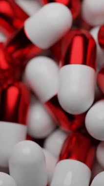 Kırmızı-beyaz haplar. Tasarım. Çizgi film animasyonunda birbirinin üstünde duran küçük kapsüller. Yüksek kalite 4k görüntü