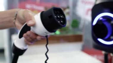 Yenilikçi ve modern tasarım özelliklerini gösteren elektrikli bir aracın şarj konnektörünün yakın görüntüsü. Medya
