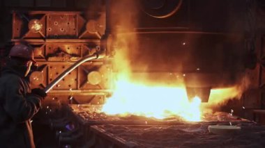 Yüksek sıcaklıktaki dökümhane ortamında, yetenekli bir işçi hassas bir şekilde erimiş metal dökmeyi ustalıkla yönetir. Menkul Kıymetler