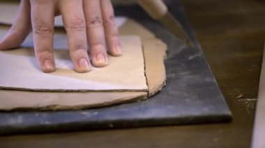 Becerikli bir zanaatkar yumuşak bir yüzey üzerinde, karmaşık çömlekçilik teknikleri ve sanatsal beceriler sergileyerek yumuşak killeri şekillendirir. Menkul Kıymetler