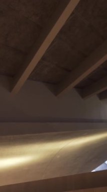 View from the bottom on the light wooden ceiling cover with wooden beams and sunlight passing through the windows. Concept: eco-friendly beautiful finishing materials