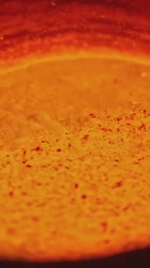 Fabrikada fokurdayan metalin yakın çekimi. Stok görüntüleri. Çukurda metal parlak kütle. Metalurji fabrikasında erimiş metal sıvısı kaynıyor..