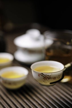 Çay, zarif çay fincanları ve rahatlamanın özünü yakalayan büyüleyici bir çaydanlık içeren sakin bir sahne.