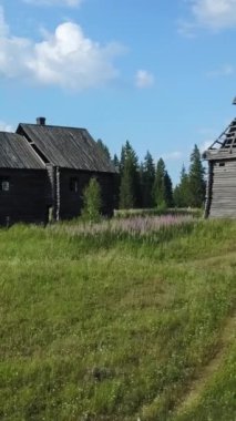 Yeşilliğe yuva yapmış büyüleyici ve ilginç ahşap yapılar yukarıdaki parlak mavi gökyüzü tarafından zarif çerçevelenmiştir. Menkul Kıymetler