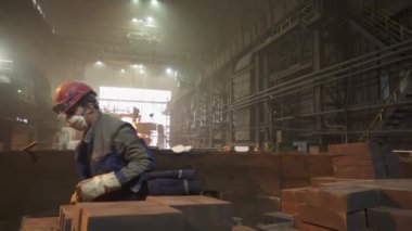 Bir sanayi işçisi yoğun ve aktif bir imalat ortamında belirli görevlere özenle konsantre olur. Menkul Kıymetler