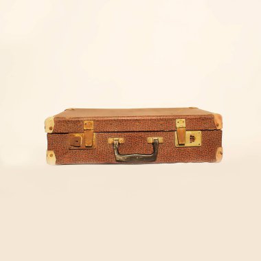 This antique brown suitcase, adorned with beautiful brass hardware, is exceptionally perfect for travel enthusiasts clipart