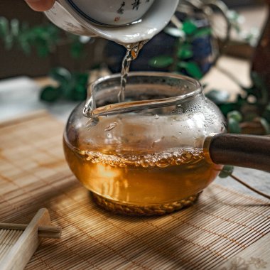 A serene moment of fragrant tea poured into a beautiful teapot, showcasing warmth and tranquility in each drop clipart