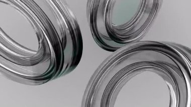 Gri arka planda dönen cam halkalar. Tasarım