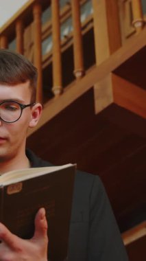 Huzurlu ve sessiz bir kütüphane ortamında ilgi çekici bir kitap okumaya dalmış genç bir adam. Medya