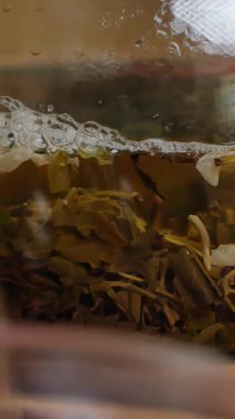 Video, cam çaydanlık ile serinletici yeşil çayı narin bir fincana dökerek rahatlatıcı bir atmosfer oluşturan sakin bir çay ayinini vurguluyor. Medya