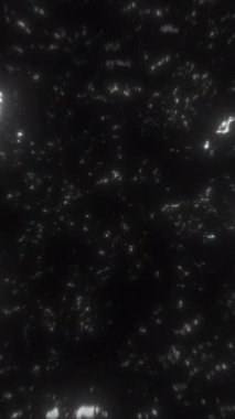 Siyah arka planda dağınık ışık lekeleri olan, derinlik ve boyut çağrıştıran ilgi çekici soyut bir kompozisyon.