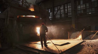 Endüstriyel bir tesiste metalin eritildiği büyüleyici bir manzara, içerdiği ısı ve işçiliği gösteriyor. Menkul Kıymetler