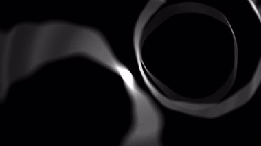 Siyah ve beyaz duman siyah arkaplanda dairesel bir şekil oluşturuyor