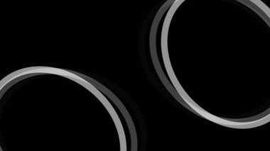 Beyaz halkalar siyah zemin üzerinde dönerek soyut ve dinamik bir görsel yaratırlar.