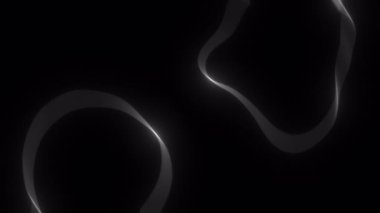 Parlayan halkaların soyut animasyonu ve düzensiz şekiller siyah arkaplan üzerinde sorunsuzca hareket ediyor