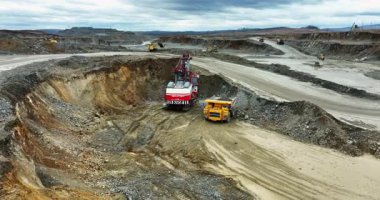 Kazıcı açık maden ocağındaki maden kamyonuna mineraller yüklüyor