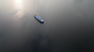 Büyük yolcu feribotu gün batımında nehirde yüzüyor. Kırp