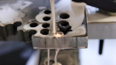 Endüstriyel lazer kesimi sırasında metal bir plakadan erimiş metal damlalar. Medya