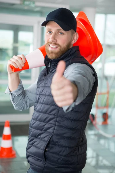 Road Worker Using Cones Indoors — Stock Photo, Image