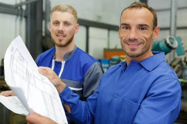 Two Engineers Holding Scale Drawings — Stock Photo, Image