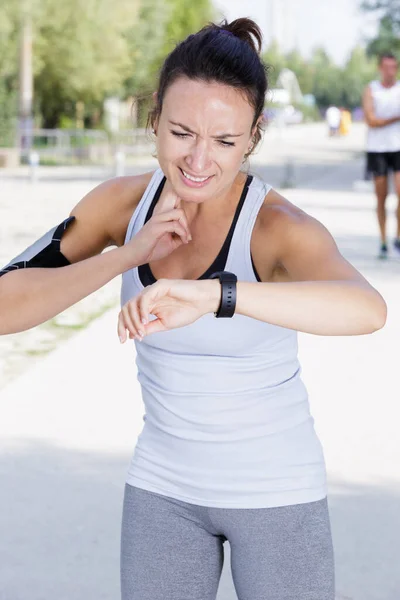 Woman Running Outdoors Using Watch — 스톡 사진