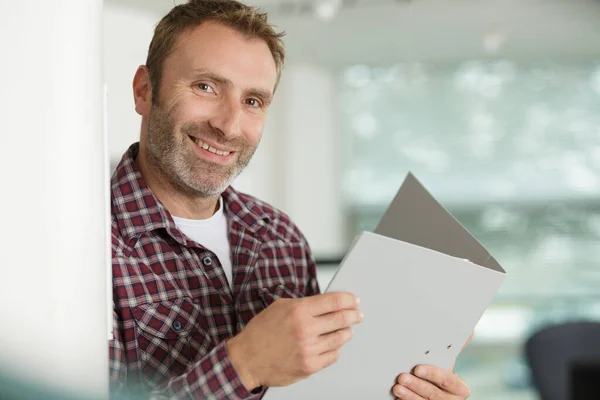 Zdjęcie Uśmiechniętego Mężczyzny Trzymającego Otwarty Folder — Zdjęcie stockowe