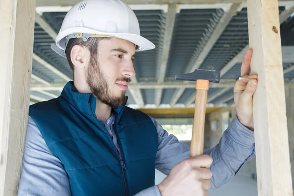 Confident Man Builder Hammer Wood Structure Indoors — Stock Photo, Image