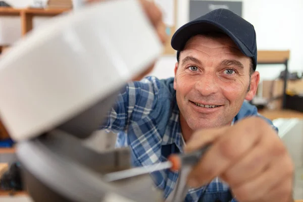 Mature Male Serviceman Repairing Refrigerator — Stock Photo, Image