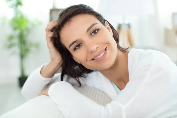 Happy Woman Sitting Leaned Couch Home Stock Photo