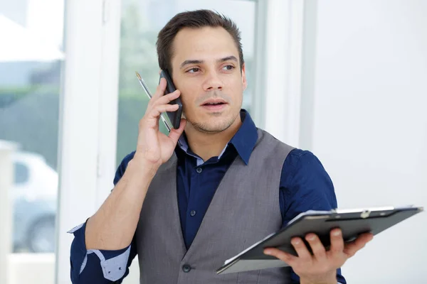 Smiling Young Man Discussing Document Phone — Stock Photo, Image