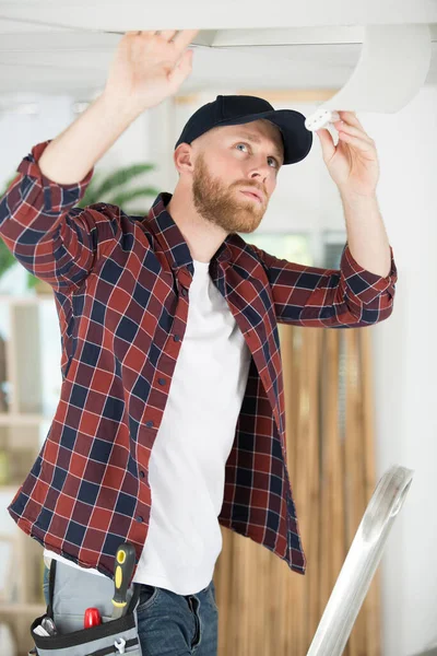 Young Handyman Installing New Bulb Ceiling Light — Stock Photo, Image