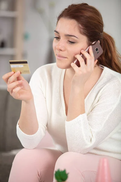 Young Woman Credit Card Sofa Talking Phone — стоковое фото