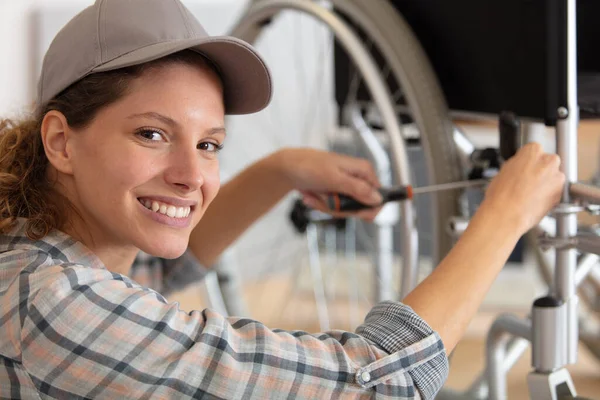 Woman Repairing Wheelchair Garage — Foto Stock