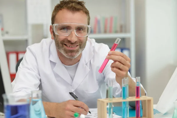 Chemist Smiling Holding Tube — Stock Photo, Image