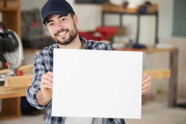 a repairman holding white board